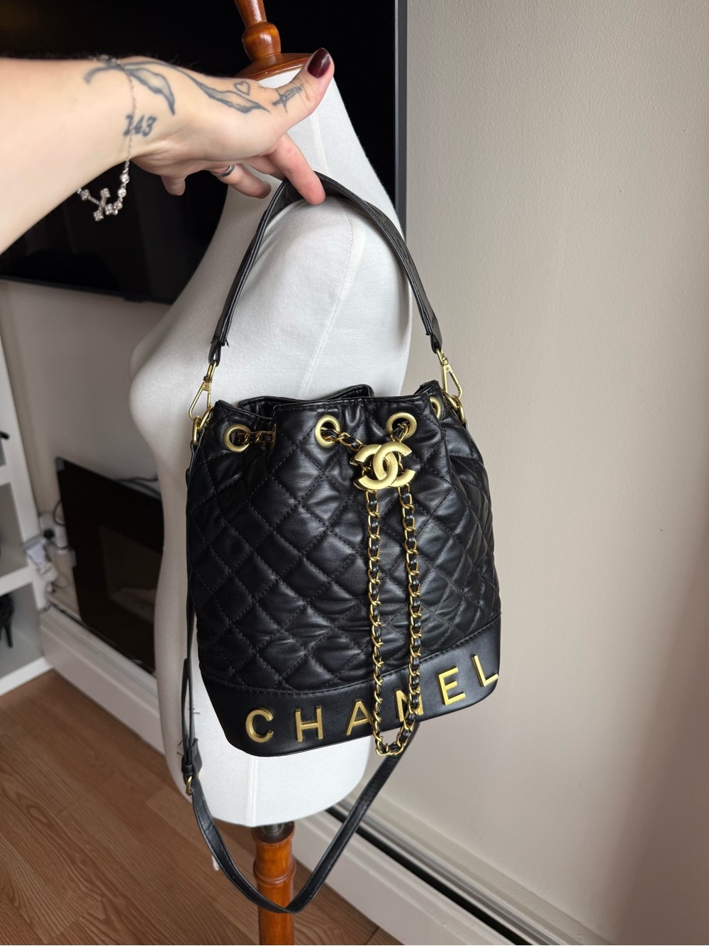 Black Quilted Drawstring Bucket Bag with Gold Hardware